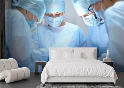 Surgical operating team performing thoracic surgery in modern hospital, health Wall mural