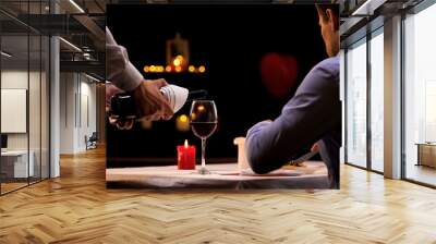 Waiter pouring male customer high-quality red wine, tasty dinner in restaurant Wall mural