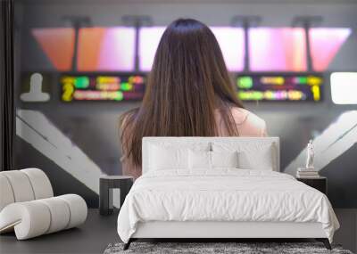 Woman looking at big screen of sports betting, gambling addiction, back view Wall mural