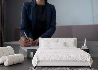 Woman signing documents to receive money, taking loan in bank, startup business Wall mural