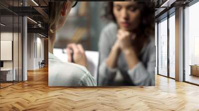 Young depressed woman talking to lady psychologist during session, mental health Wall mural