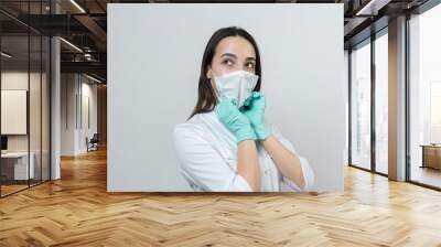 A girl doctor in latex gloves and a white coat is preparing for the procedures. Wall mural