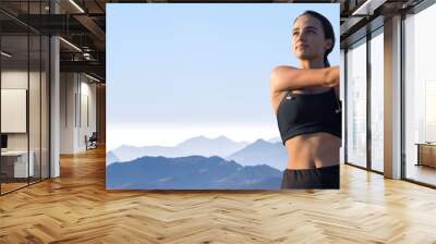 A young slim athletic girl in sportswear with snakeskin prints performs a set of exercises. Fitness and healthy lifestyle.	 Wall mural