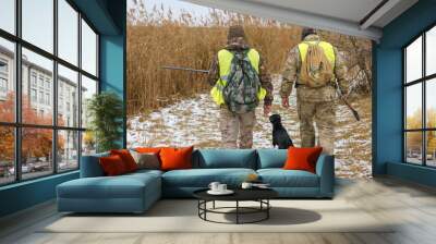 Hunters with a german drathaar and spaniel, pigeon hunting with dogs in reflective vests	 Wall mural