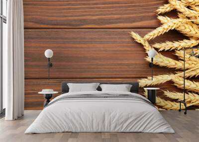 Spikelets of wheat on brown background.Top view Wall mural