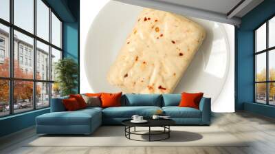 Block of halloumi cheese with red chilli on white ceramic plate isolated on white from above. Wall mural