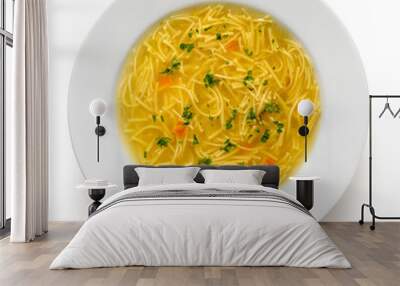 Instant chicken noodle soup in a white ceramic soup plate isolated on white. Top view. Chopped parsley. Wall mural