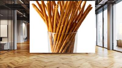 Long crunchy salty pretzel sticks in glass isolated on white. Wall mural