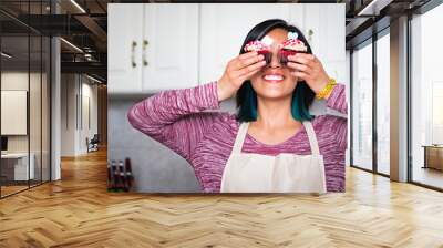 A smiling woman with two cupcakes Wall mural