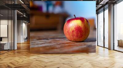 Fresh red apple on the wooden table in the darkness Wall mural