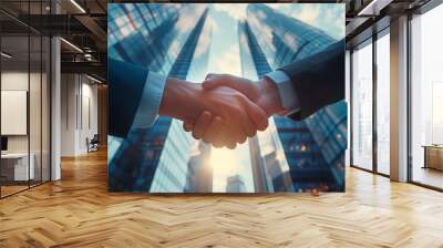 Businessmen handshake on skyscraper background at sunrise. Partnership, successful deal, agreement, business contract concept. Wall mural