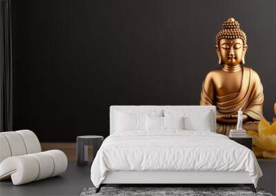 Gold Buddha statue and yellow lotus flowers on empty dark background with copy space, yoga, meditation and relaxation time Wall mural