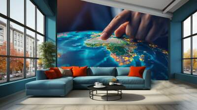 The world in the hands of finance, a businessman pointing Africa on earth globe map with index finger, showing continent resources, planning global business strategy Wall mural