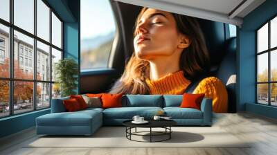 A young woman resting peacefully in a car, enjoying a serene moment with sunlight filtering through the window. Wall mural