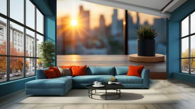 serene view of potted plant on wooden table, with stunning sunset illuminating cityscape in background. warm light creates peaceful atmosphere Wall mural