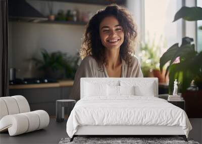 Beautiful woman smiling with a cup of coffee in the kitchen of her home Wall mural