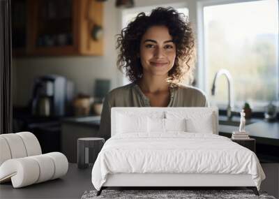 Beautiful woman smiling with a cup of coffee in the kitchen of her home Wall mural