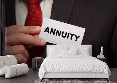 Businessman putting a card with text ANNUITY in the pocket Wall mural