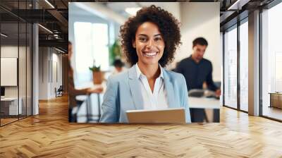 Businesswoman with a tablet in her hands stands in the background of the office and colleagues Wall mural