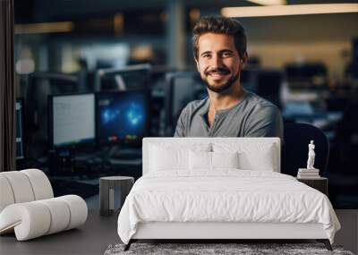 Cheerful programmer man working with computers in office. Wall mural