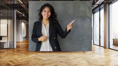 Confident professional presenting, woman with open hand gesture Wall mural