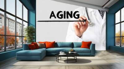 Doctor writing word Aging with marker, Medical concept Wall mural