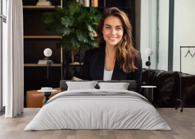 Happy professional female psychologist holding clipboard sitting at sofa in her office Wall mural