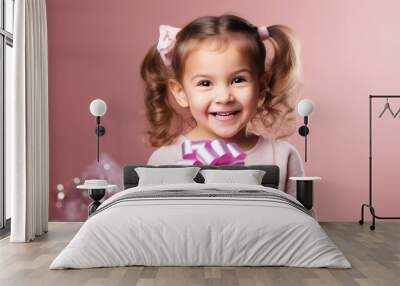 Happy smiling girl holding gift box on a colored background Wall mural