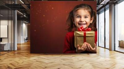 Happy smiling girl holding gift box on a colored background Wall mural