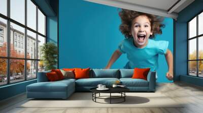 Little boy exited smiling on blue background. Created with Generative AI technology. Wall mural