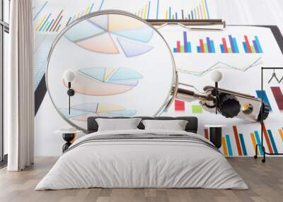 Magnifying glass lying on business charts and graphs. Business planning,accounting,analysis,financial planning and data Analysis concept Wall mural