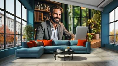 Middle aged businessman smiling while using his laptop in home office.Сreated with Generative AI technology. Wall mural