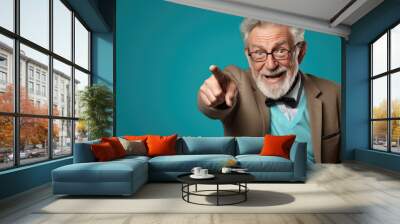 Senior man pointing with hand and finger to the side looking at the camera. Wall mural