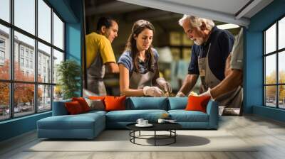 Several volunteers, both men and women, work diligently in an indoor setting to serve food to community members during a charity event. Wall mural