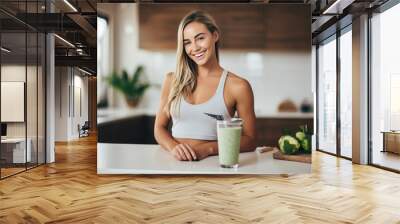 Sporty girl on a diet made a smoothie in the kitchen Wall mural