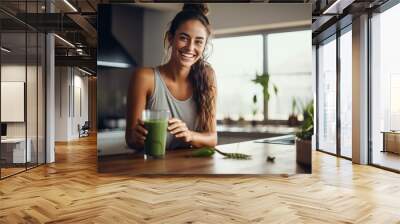 Sporty girl on a diet made a smoothie in the kitchen Wall mural