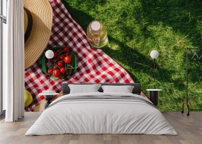 Summer picnic scene over lush green grass. Wall mural