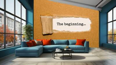 The text The beginning appearing behind torn brown paper Wall mural