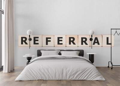 Word REFERRAL written on wood block. Business concept Wall mural