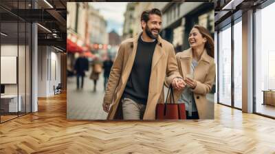 Young couple is walking down the street with bags while shopping Wall mural