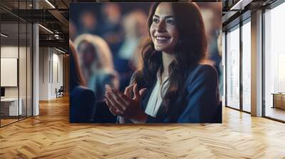 Young Female Sitting in a Crowded Audience at a Conference and Applauding After Speech. Wall mural