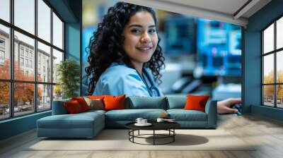 young medical professional with curly hair, wearing a blue scrub top and a stethoscope Wall mural