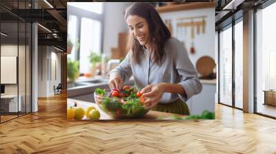 Young woman cooking in the kitchen Wall mural