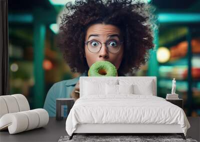 Young woman eating a donut Wall mural