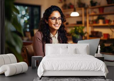 Young woman working on a laptop. Wall mural