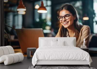 Young woman working on a laptop. Wall mural