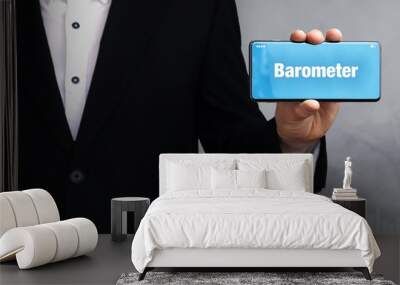 Barometer. Businessman in a suit holds a smartphone at the camera. The term Barometer is on the phone. Concept for business, finance, statistics, analysis, economy Wall mural