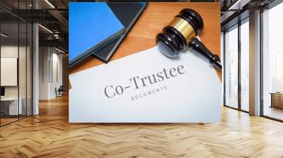 Co-Trustee. Document with label. Desk with books and judges gavel in a lawyer's office. Wall mural