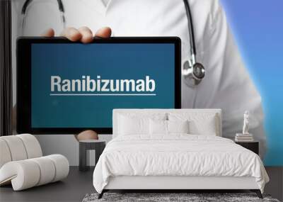 Ranibizumab. Doctor in smock holds up a tablet computer. The term Ranibizumab is in the display. Concept of disease, health, medicine Wall mural