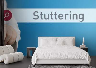 Stuttering. Doctor in smock points with his finger to a search box. The word Stuttering is in focus. Symbol for illness, health, medicine Wall mural